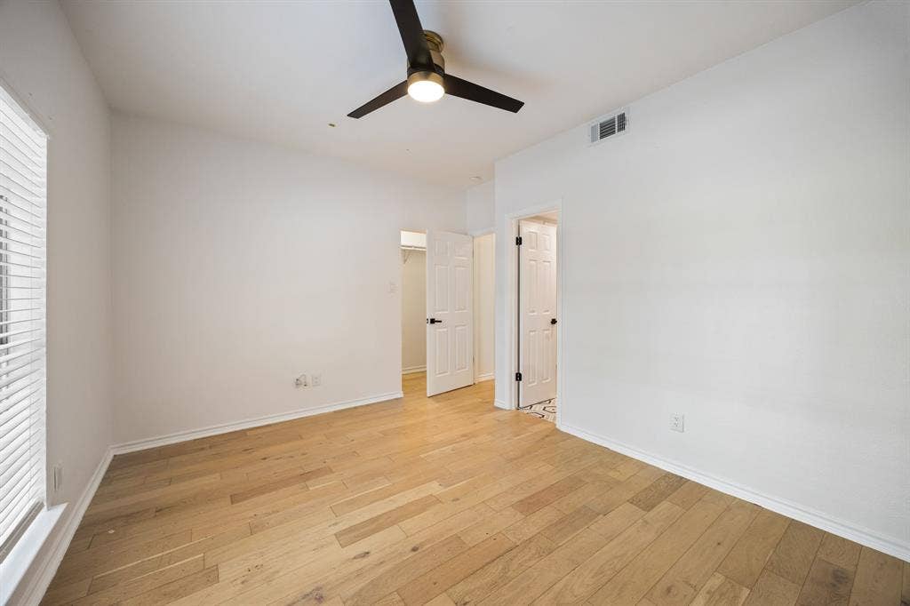 9801 Royal Lane, #701, Dallas, TX 75231 Light wood-finish flooring, white walls, and a ceiling fan with integrated lighting
