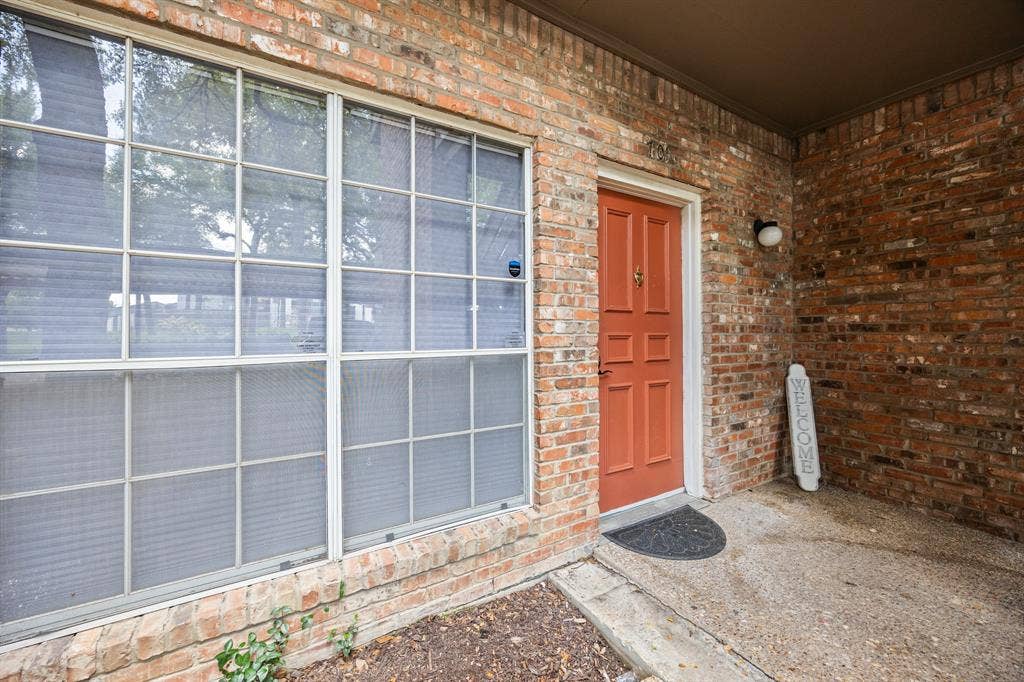 9801 Royal Lane, #701, Dallas, TX 75231 Brick exterior with a covered entry