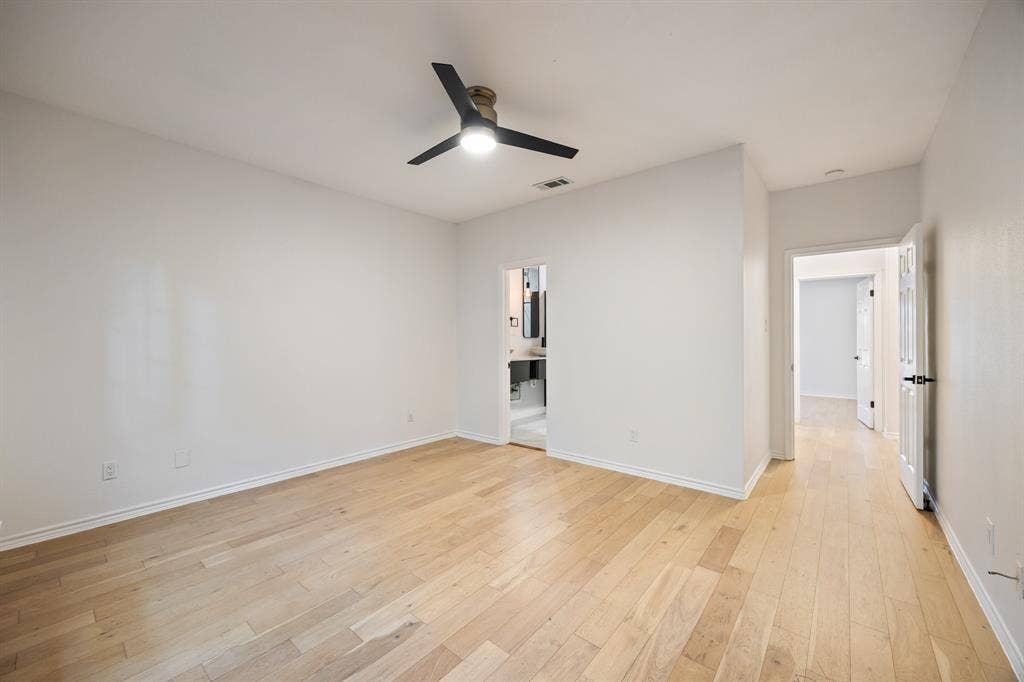 9801 Royal Lane, #701, Dallas, TX 75231 Spacious room with wood-finish flooring, a modern ceiling fan, and crisp white walls