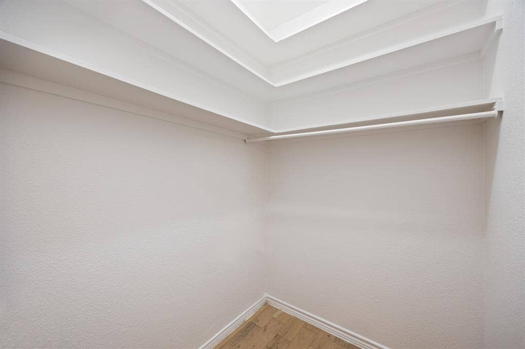 9801 Royal Lane, #701, Dallas, TX 75231 Recessed ceiling lighting, crown molding, wall-mounted shelving, and wood-finish flooring