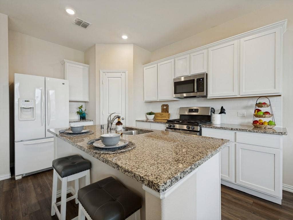 1512 Fields View Drive, Anna, TX 75409 Beautiful granite countertops and a gas range with microwave above.