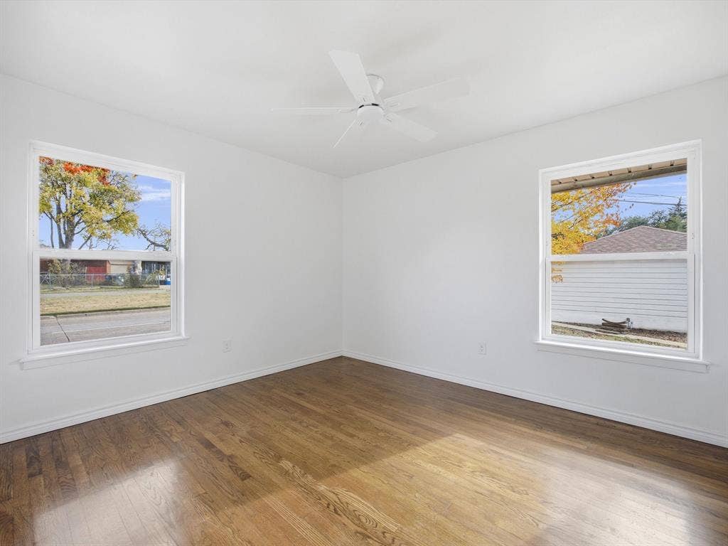 10270 Kilkenny Place, Dallas, TX 75228 Bright interior with wood-finish flooring, two large windows, a ceiling fan, and white walls