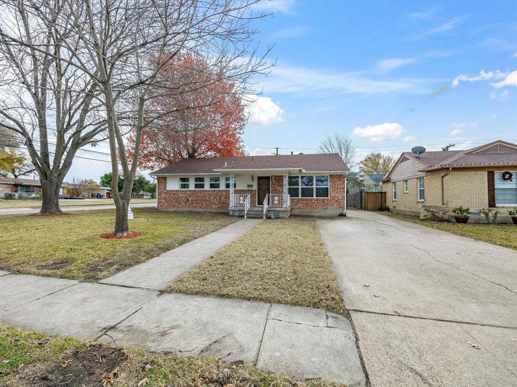 10270 Kilkenny Place, Dallas, TX 75228 Brick and siding exterior, concrete driveway, concrete walkway, mature trees, and a covered entry
