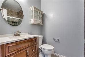 5726 Marvin Loving Drive, #221, Garland, TX 75043 Elegant half bath featuring a wood-finish vanity with dual drawers, white quartz countertop, and chrome faucet
