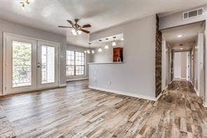 5726 Marvin Loving Drive, #221, Garland, TX 75043 Wood-finish flooring throughout, French doors with balcony access, recessed lighting, and a ceiling fan