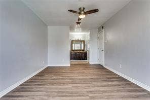 5726 Marvin Loving Drive, #221, Garland, TX 75043 Wood-finish flooring, ceiling fan with integrated lighting, and a white interior door