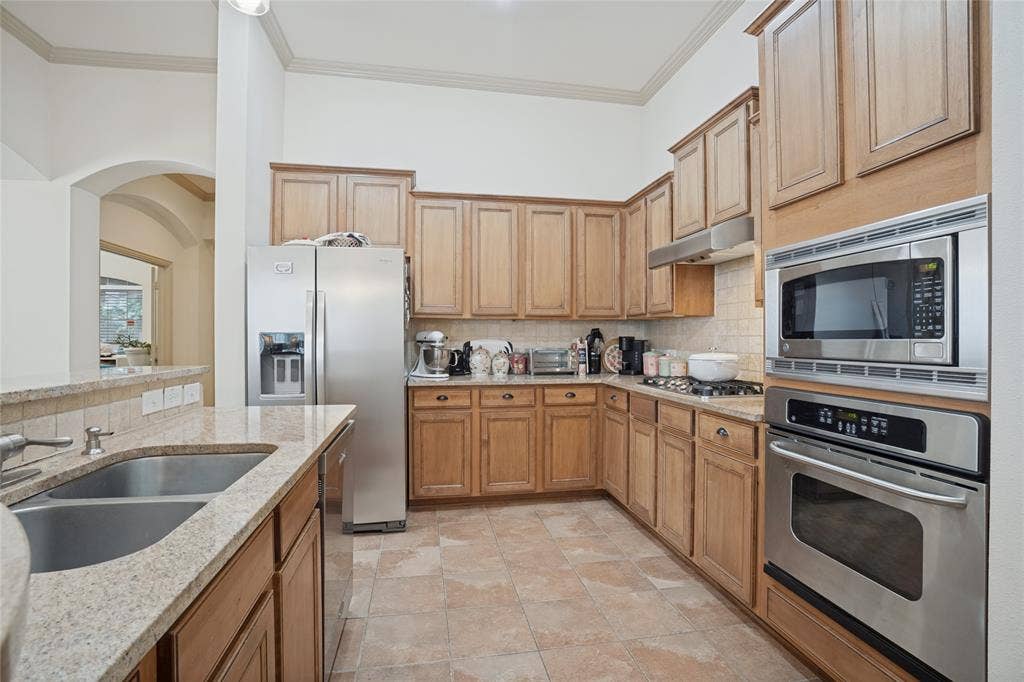 Stainless steel appliances and abundant counter space make meal preparation a breeze, offering plenty of room for the cook of the household to create and entertain.