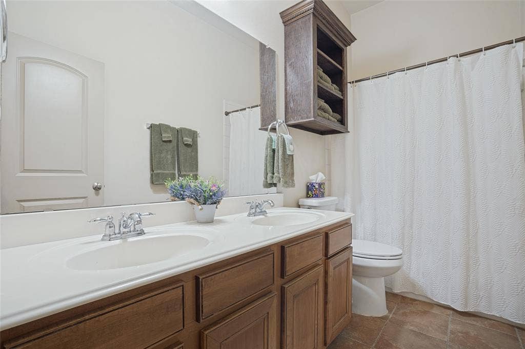 The conveniently located secondary bathroom offers a clean, functional space designed to accommodate family members and guests with comfort and ease.