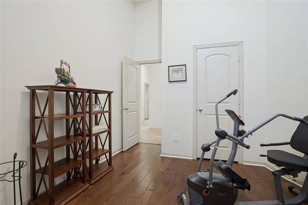 Currently set up as a workout room, this spacious secondary bedroom showcases the versatility of the home's flexible floor plan. Perfect for a home gym, guest bedroom, hobby room, or whatever best fits your lifestyle.