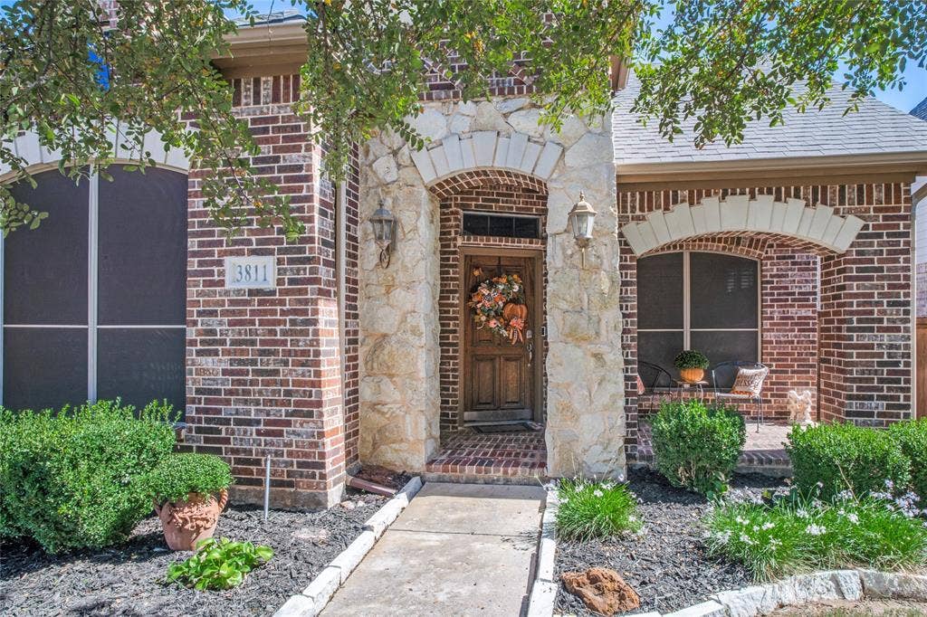 Freshly mulched flower beds adding a clean, polished touch to the inviting exterior.