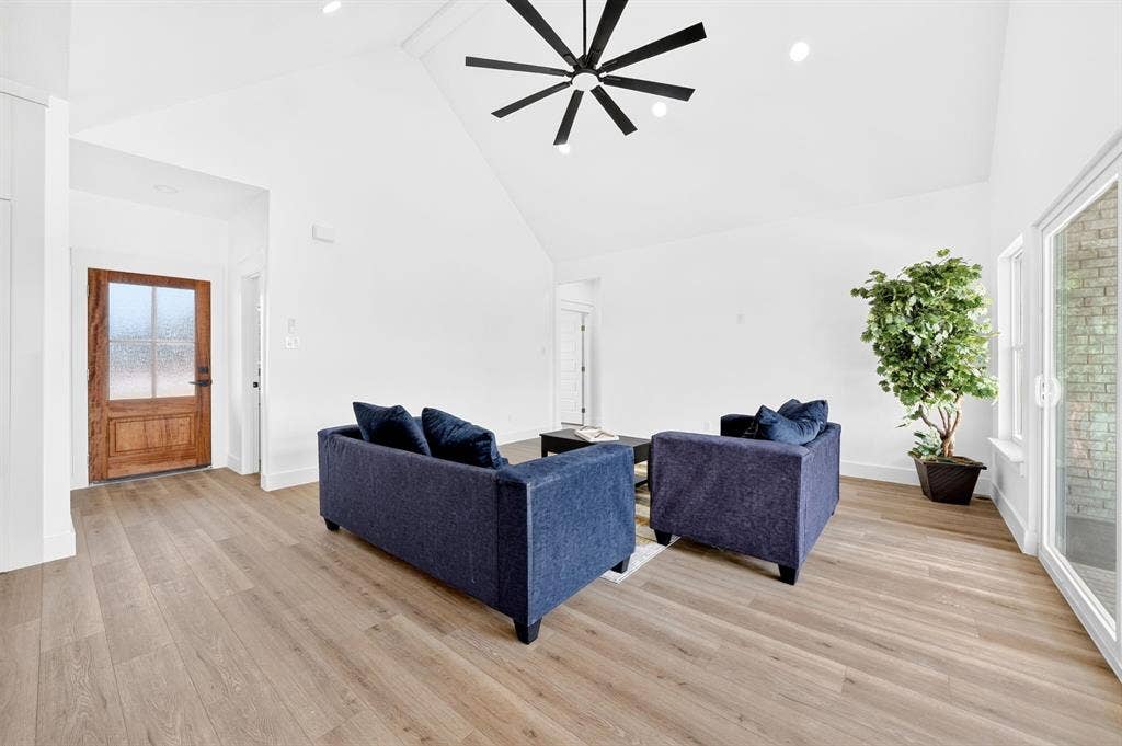 5731 Lewis Court, Athens, TX 75752 Vaulted ceiling with a black ceiling fan, recessed lighting, wood-finish flooring, and a glass-paneled wooden entry door