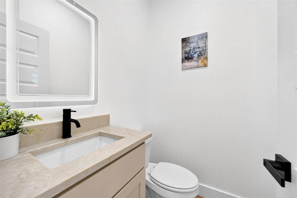 5731 Lewis Court, Athens, TX 75752 Integrated vanity with a rectangular sink, light-toned countertop, and matte black faucet
