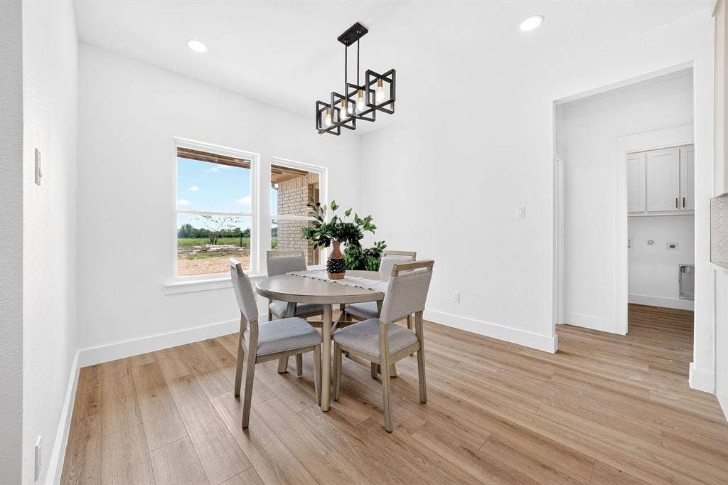 5731 Lewis Court, Athens, TX 75752 Wood-finish flooring, recessed ceiling lighting, and a modern black linear chandelier