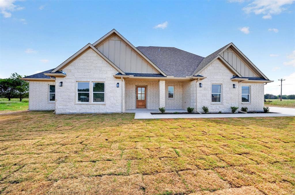 5731 Lewis Court, Athens, TX 75752 Stone veneer exterior, gable rooflines, covered entry, wood-finish front door, and multiple windows