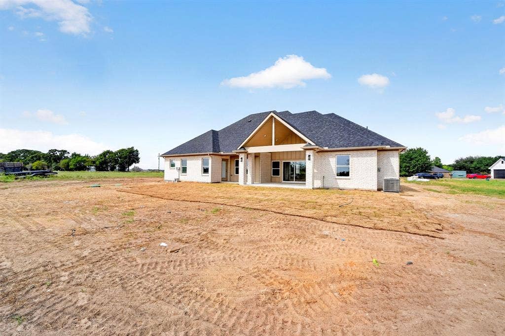 5731 Lewis Court, Athens, TX 75752 White brick exterior, dark shingle roof, covered patio, sliding glass doors, exposed wood-finish gables