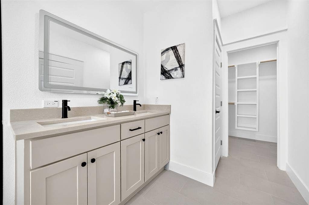 5731 Lewis Court, Athens, TX 75752 Double vanity with integrated sinks, light-toned countertop, and matte black fixtures