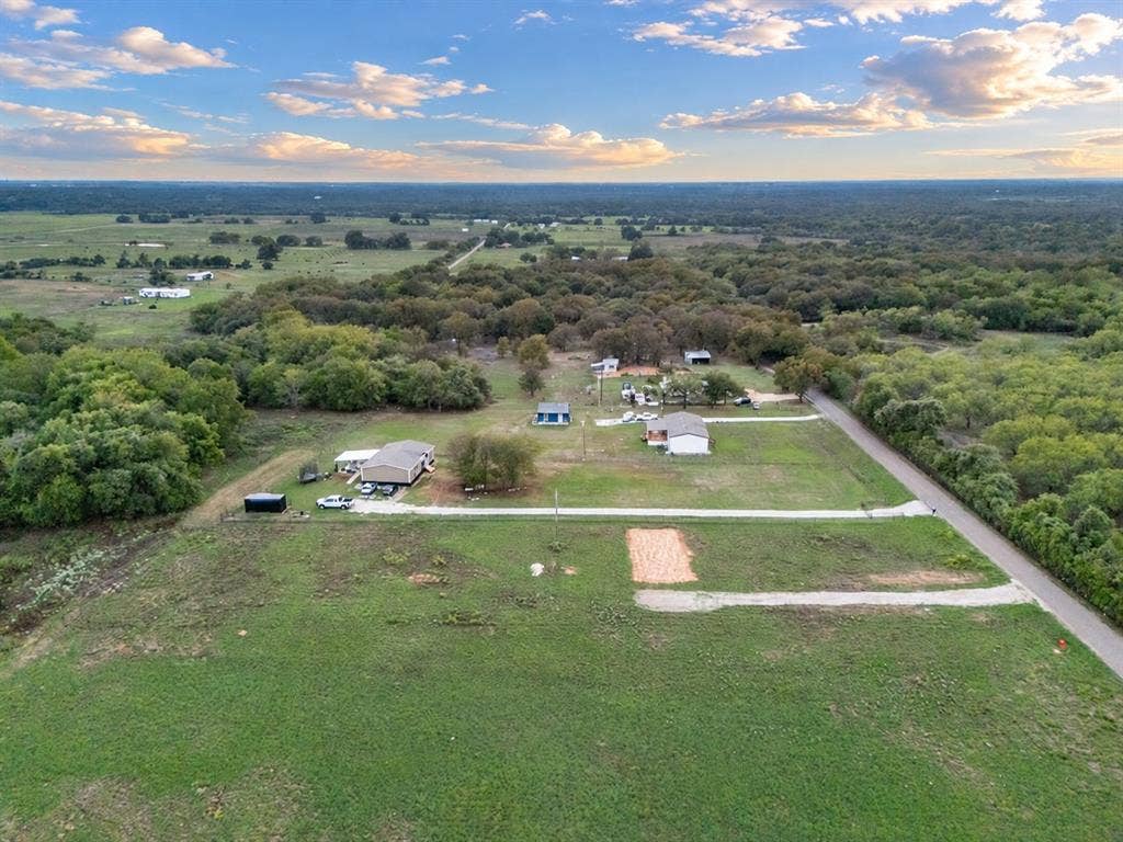 TBD MARY WARE, Waco, TX 76705 Expansive acreage featuring multiple structures, mature trees, and a paved road frontage