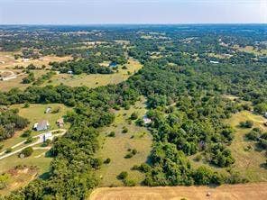 6630 Prather Road, Springtown, TX 76082 Expansive rural property featuring a mix of open fields, wooded areas, and scattered residential structures