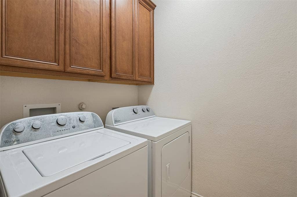 3236 Twist Trail, Plano, TX 75093 White washer and dryer appliances, wood-finish cabinetry, and neutral wall tones