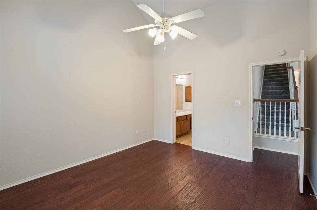 3236 Twist Trail, Plano, TX 75093 Vaulted ceiling with a ceiling fan, wood-finish flooring, and direct access to a bathroom with a vanity
