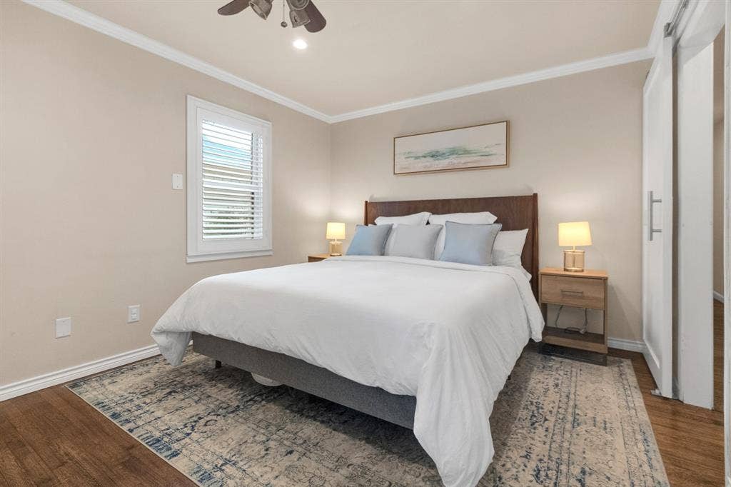 1815 Oates Drive, Dallas, TX 75228 Bedroom featuring wood-finish flooring, crown molding, and a ceiling fan with integrated lighting