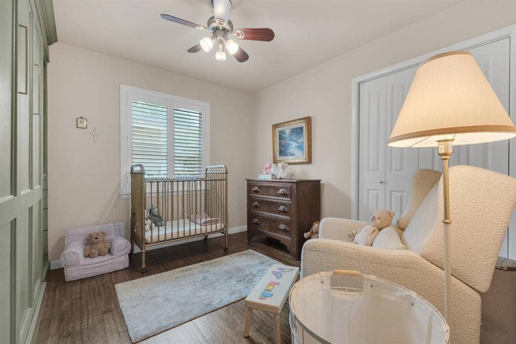 1815 Oates Drive, Dallas, TX 75228 Room featuring wood-finish flooring, a ceiling fan with integrated lighting, and a window with plantation shutters