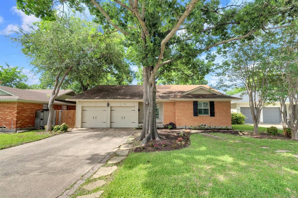 1815 Oates Drive, Dallas, TX 75228 Brick exterior with a mature tree in the front yard