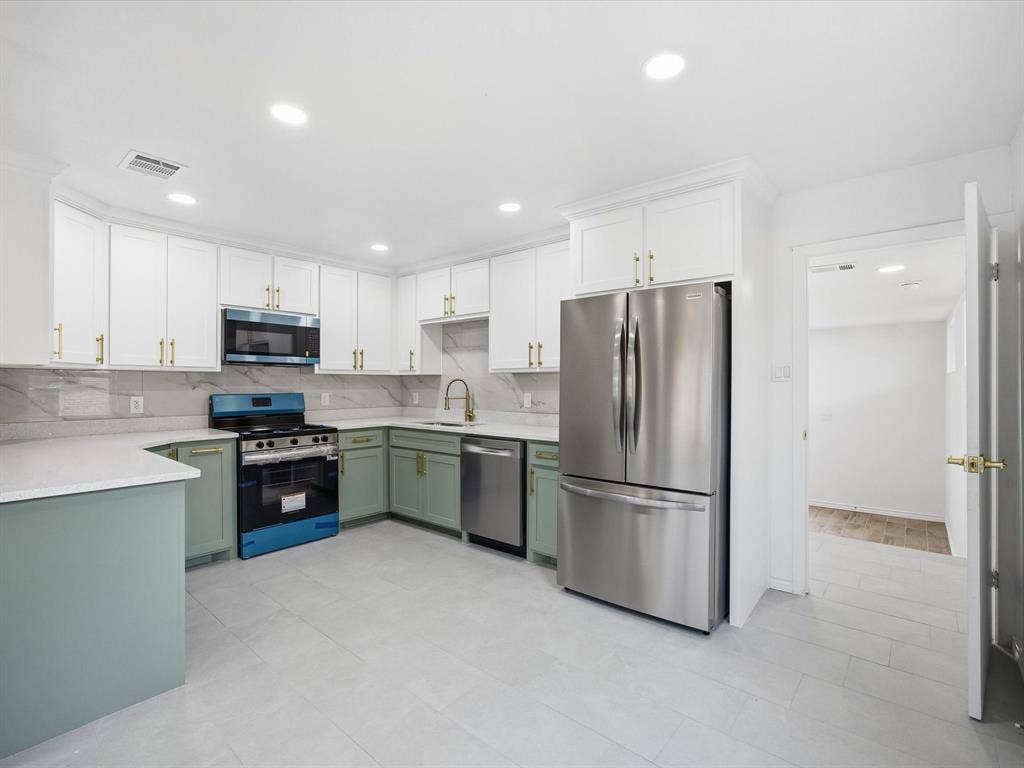 10270 Kilkenny Place, Dallas, TX 75228 Contemporary kitchen featuring two-tone cabinetry, stainless steel appliances, light-toned countertops, tile flooring, and recessed lighting