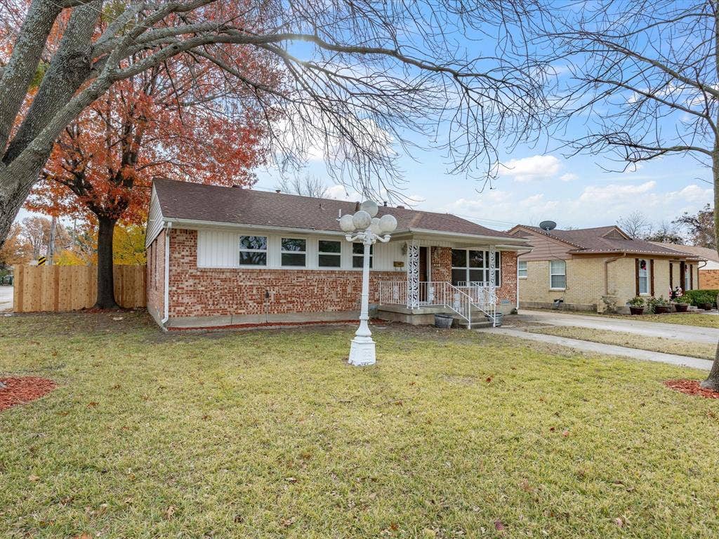 10270 Kilkenny Place, Dallas, TX 75228 Brick and white siding exterior with a covered porch, established trees, and a concrete driveway