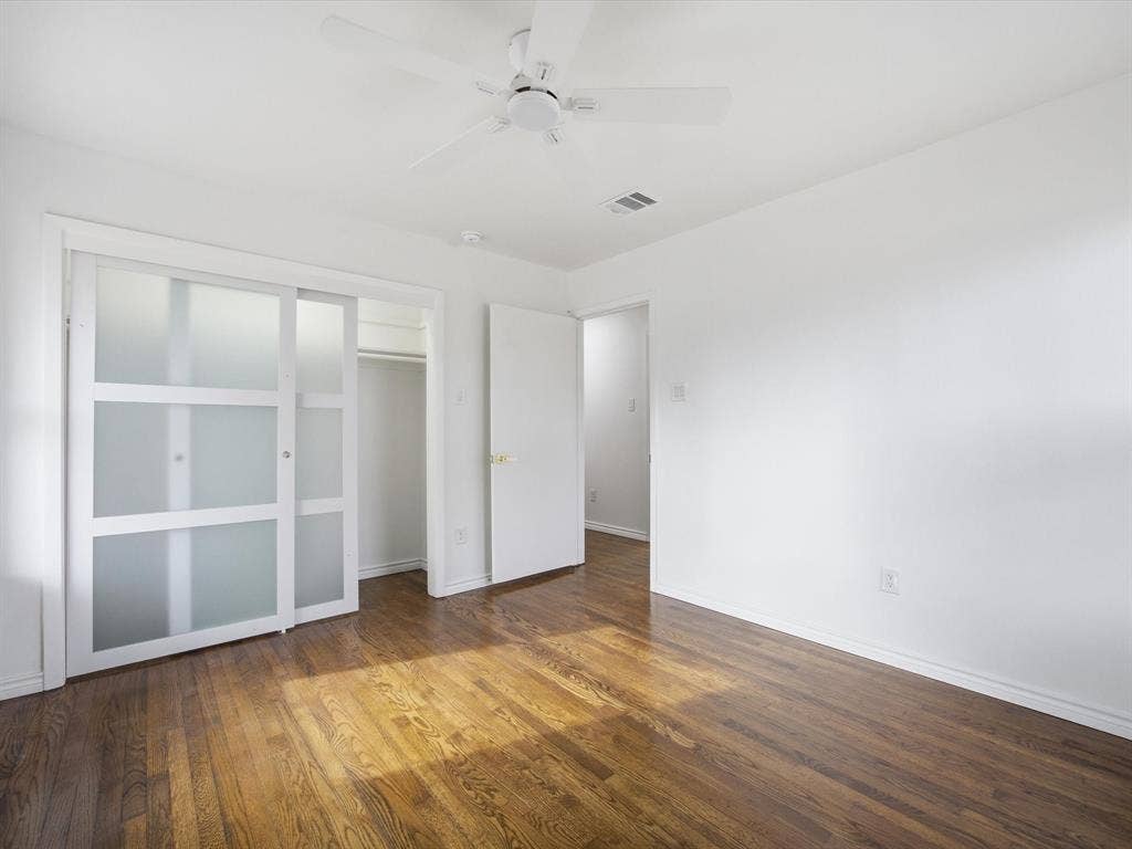 10270 Kilkenny Place, Dallas, TX 75228 Hardwood flooring, white walls, ceiling fan, white trim, sliding closet doors with frosted panels