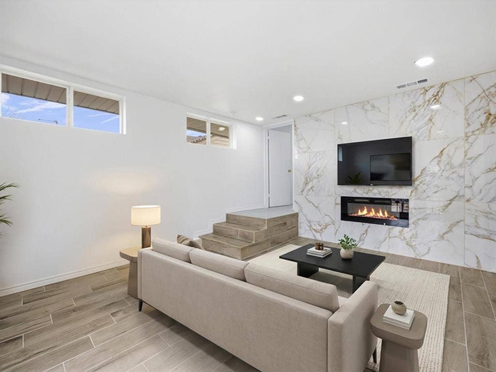 10270 Kilkenny Place, Dallas, TX 75228 Tiled accent wall with an inset linear fireplace, recessed lighting, wood-finish flooring, and multiple windows