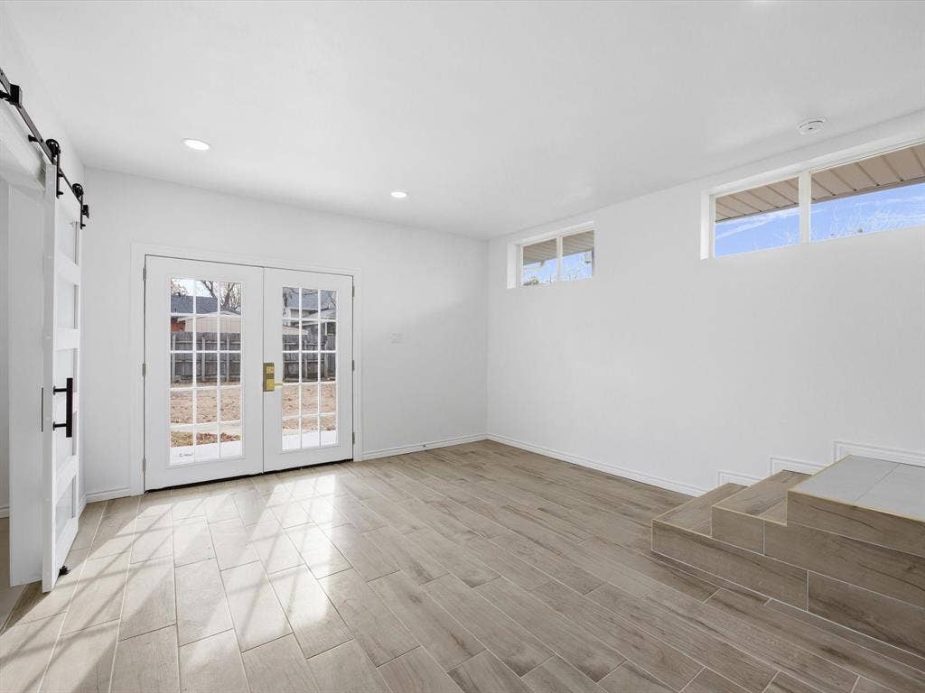 10270 Kilkenny Place, Dallas, TX 75228 White walls, recessed lighting, wood-finish tile flooring, and a barn door entry