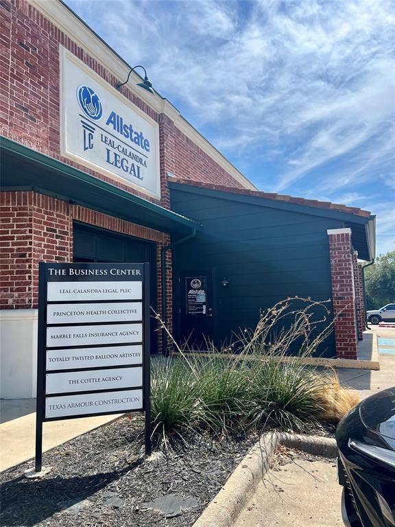 123 W Princeton Drive, #200, Princeton, TX 75407 Red brick exterior with dark green siding