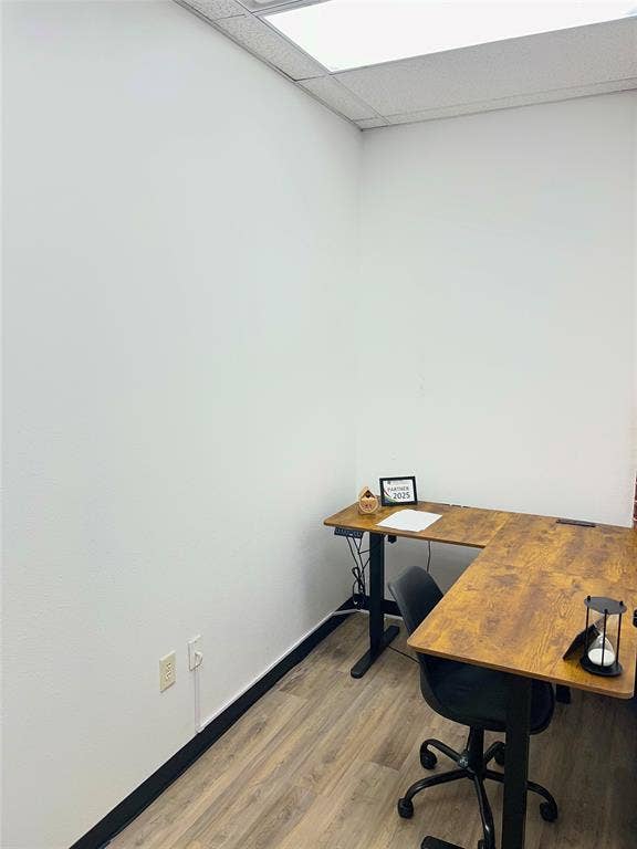 123 W Princeton Drive, #200, Princeton, TX 75407 Wood-finish flooring, white walls, and a dropped ceiling with integrated lighting
