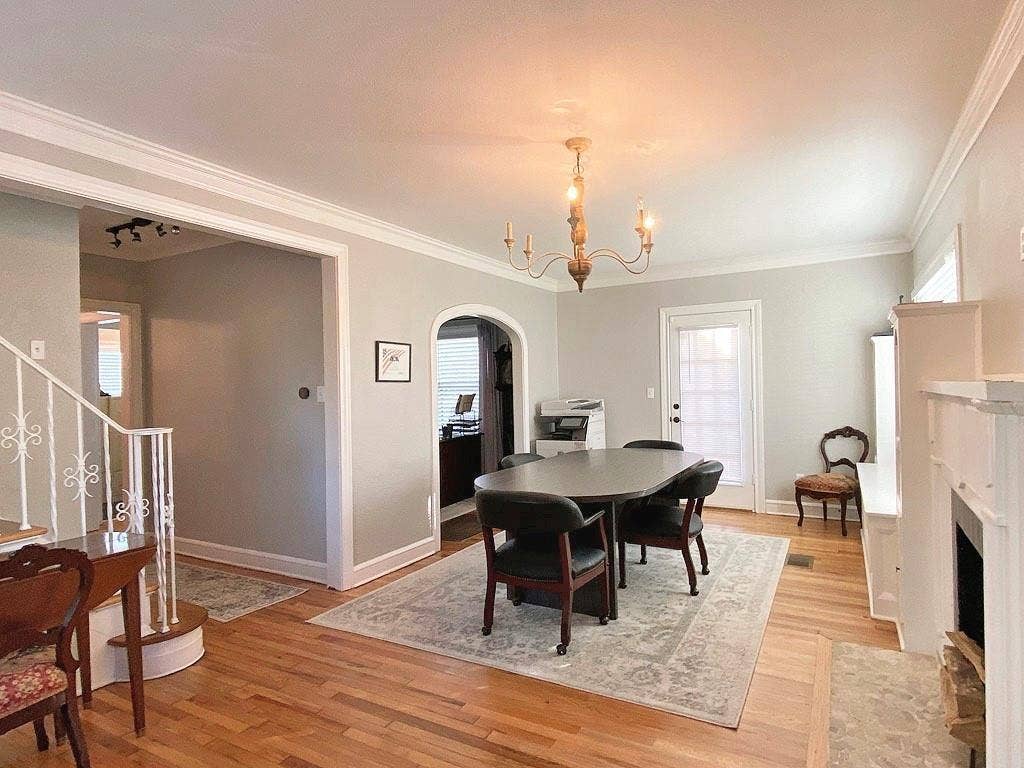 434 S Vine Avenue, Tyler, TX 75702 Hardwood flooring, crown molding, built-in fireplace, arched entryway, and a candelabra-style chandelier