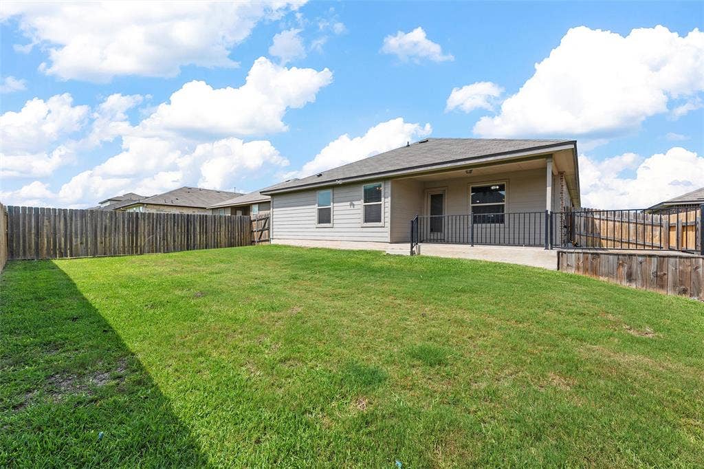 3217 Beutel Road, Lorena, TX 76655 Back of house with a patio and a fenced backyard
