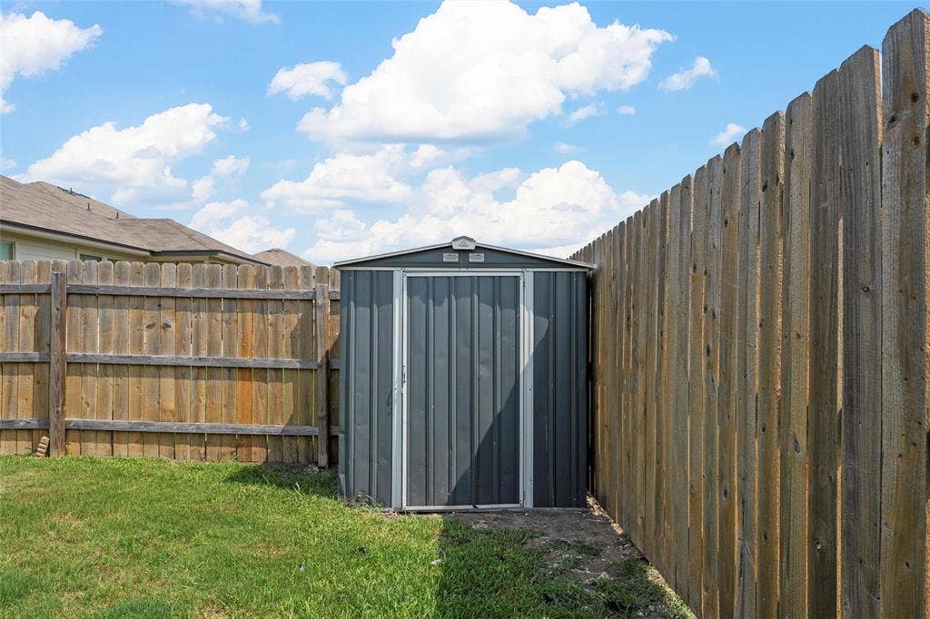 3217 Beutel Road, Lorena, TX 76655 View of shed with a fenced backyard