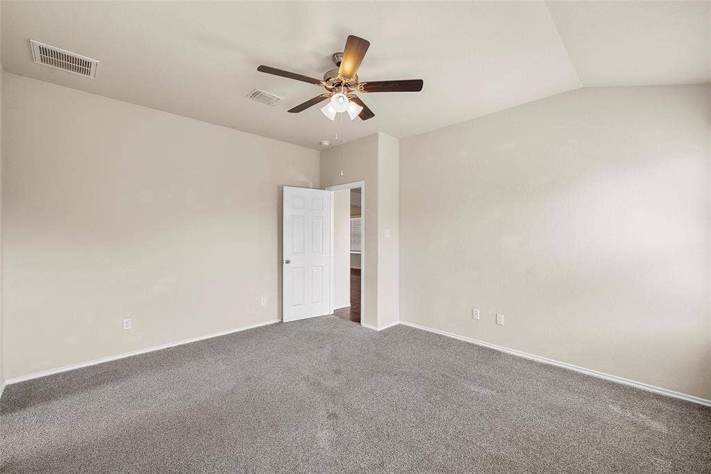 3217 Beutel Road, Lorena, TX 76655 Carpeted empty room with ceiling fan and vaulted ceiling