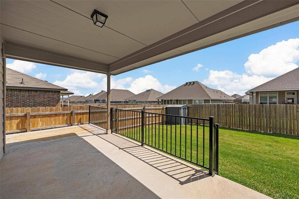 3217 Beutel Road, Lorena, TX 76655 Fenced backyard with a patio, a shed, and a residential view