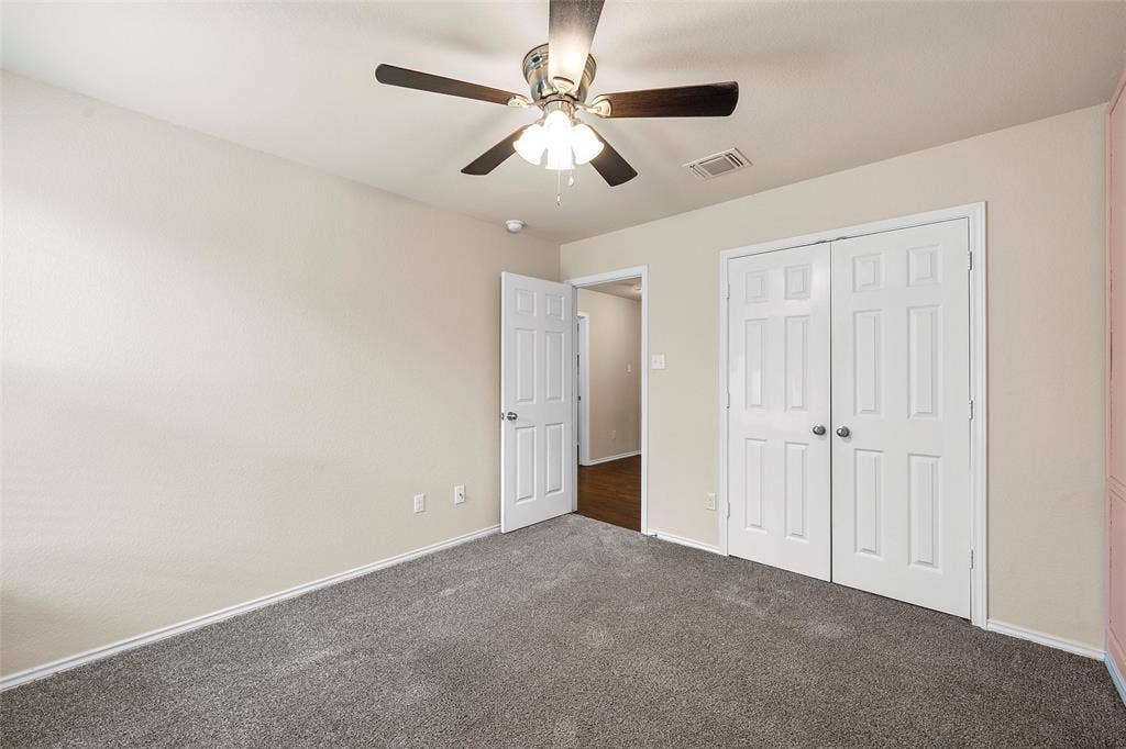 3217 Beutel Road, Lorena, TX 76655 Unfurnished bedroom featuring carpet, a closet, and ceiling fan