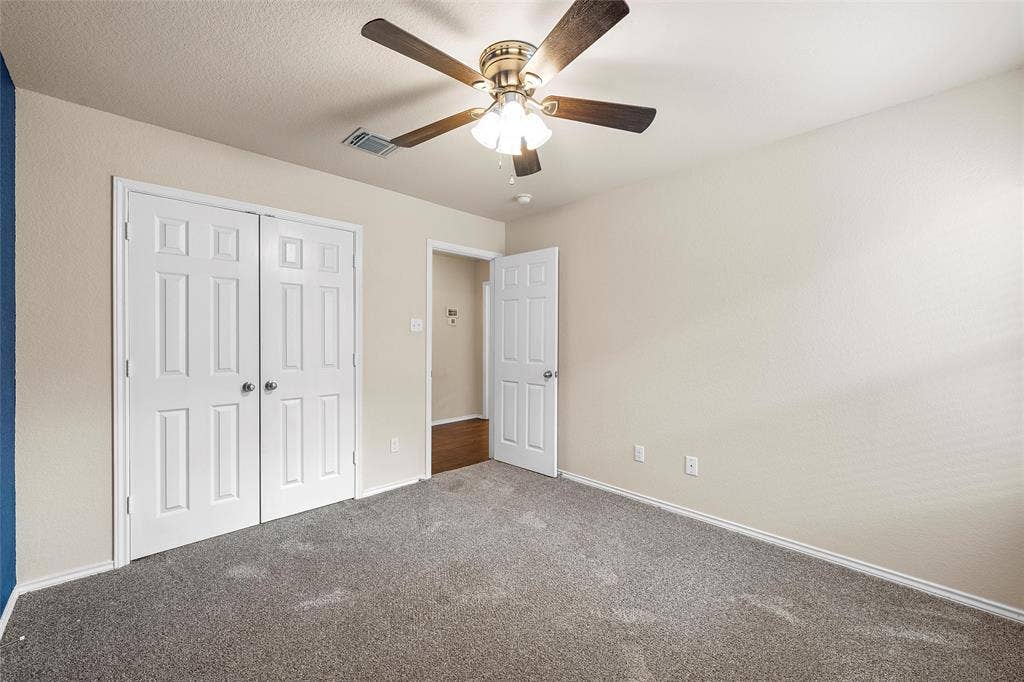 3217 Beutel Road, Lorena, TX 76655 Unfurnished bedroom with carpet flooring, a closet, and ceiling fan