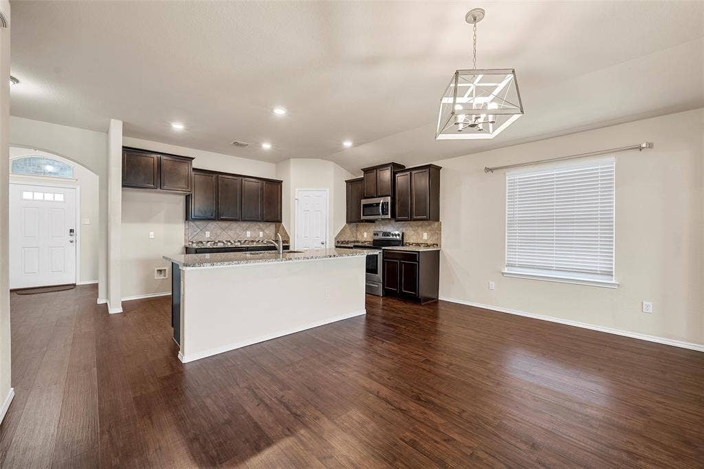 3217 Beutel Road, Lorena, TX 76655 Kitchen with stainless steel appliances, dark brown cabinetry, tasteful backsplash, a kitchen island with sink, and recessed lighting
