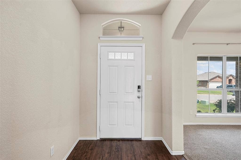 3217 Beutel Road, Lorena, TX 76655 Foyer featuring arched walkways, healthy amount of natural light, and dark wood-style flooring