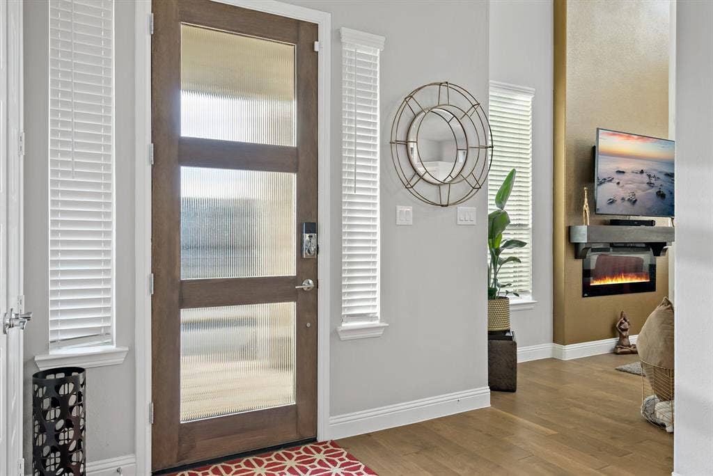 Warm wood-finish flooring extending into the main living space