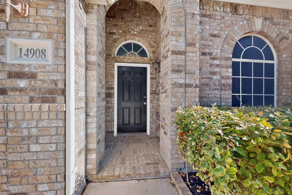 14908 Riverside Drive, Little Elm, TX 75068 Brick facade with arched entry and complementing arched window