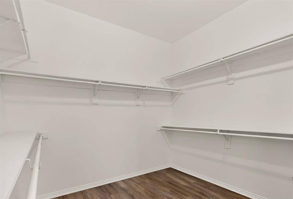 14908 Riverside Drive, Little Elm, TX 75068 White built-in shelving, white clothes rods, and wood-finish flooring