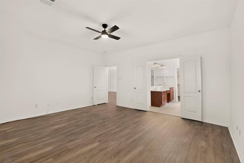 14908 Riverside Drive, Little Elm, TX 75068 Spacious room featuring wood-finish flooring, a ceiling fan with integrated lighting, and white walls