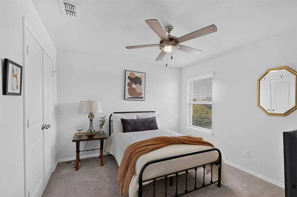 11700 Aldermoor Court, Fort Worth, TX 76036 Built-in closet with double doors, overhead ceiling fan with lighting, window with blinds, and wall-to-wall carpeting