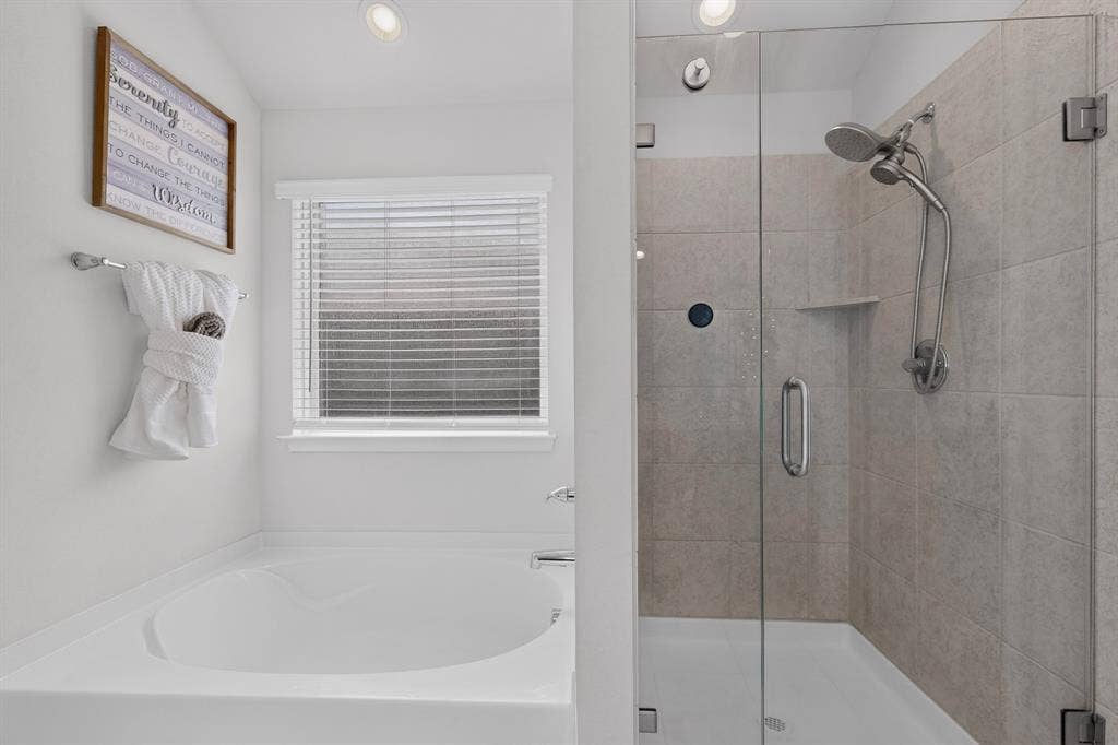 11700 Aldermoor Court, Fort Worth, TX 76036 Built-in soaking tub, separate glass-enclosed shower with tile surround, recessed lighting, and a window with blinds