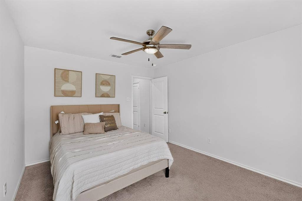 11700 Aldermoor Court, Fort Worth, TX 76036 Neutral wall tones, carpeted flooring, and a ceiling fan with integrated lighting